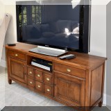 F63. Wooden entertainment center. 30”h x 70”w x 19”d 
